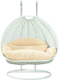 LeisureMod 2 Person Wicker Egg Chair Outdoor Indoor Bedroom Patio Hanging Lounge Swing Hammock Chairs with White Stand and UV Resistant Cushions (Cream)