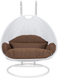 LeisureMod 2 Person Hanging Egg Chair, Indoor Outdoor Patio Lounge Swing with White Stand & UV-Resistant Cushions, Hammock Chair for Bedroom & Garden, Brown